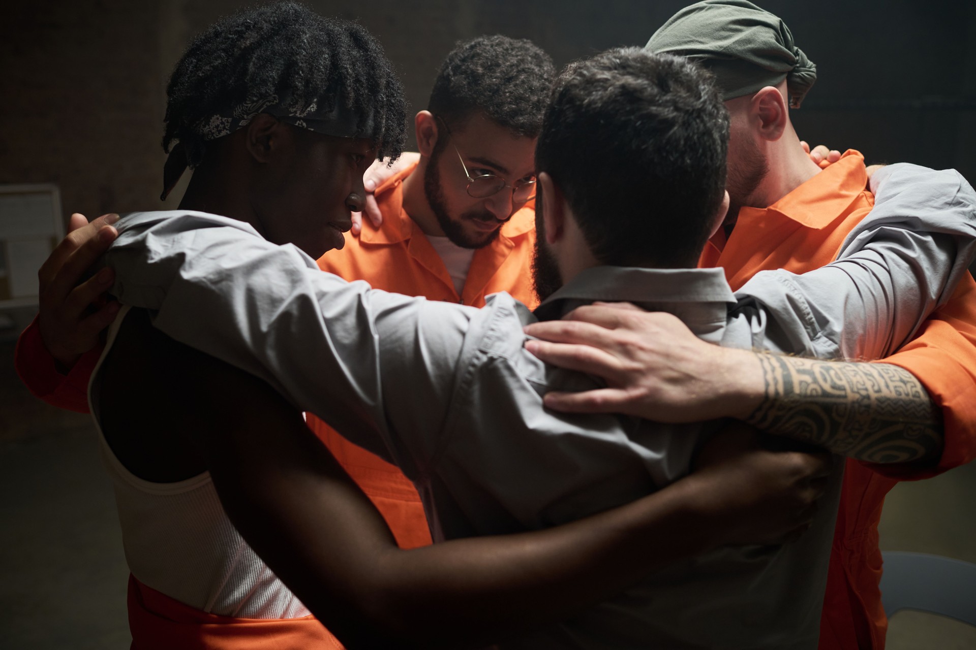 Multiethnic Young Adult Men Embracing and Supporting Each Other in Prison