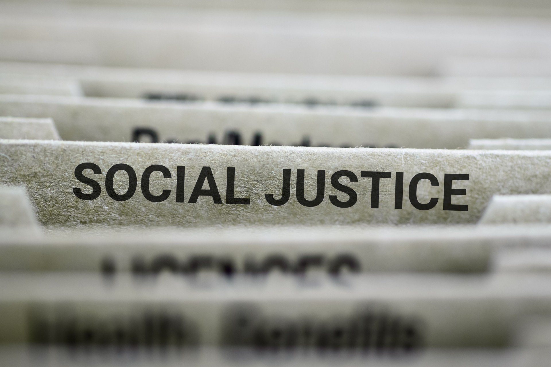 File labeled 'Social Justice' in vertical organizer.